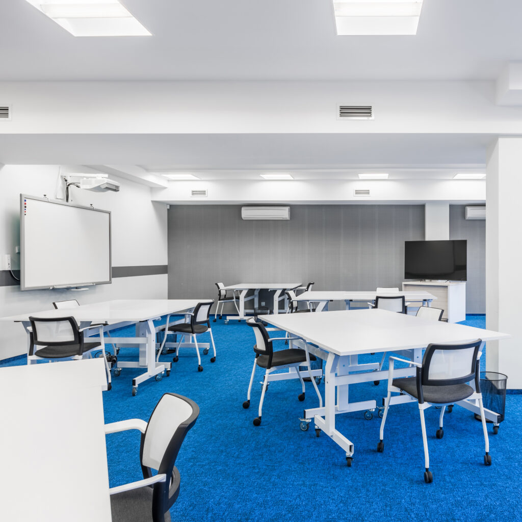 Modern,university,group,study,room,with,white,desks,and,chairs